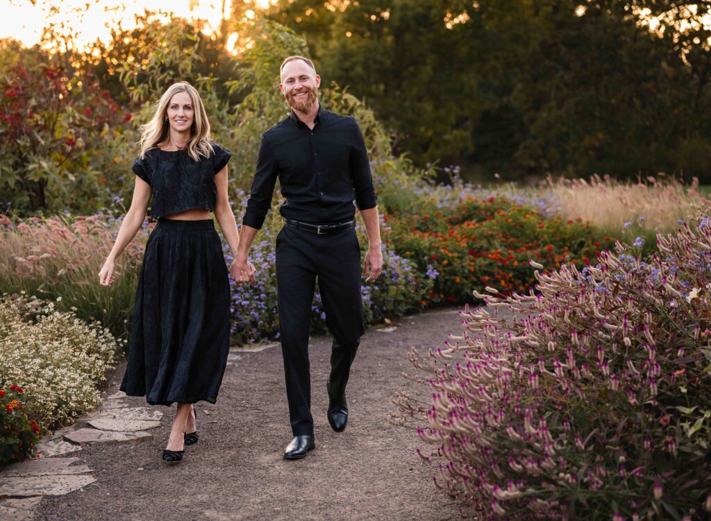Couple walking hand-in-hand at sunset during a couples photo session in St. Louis