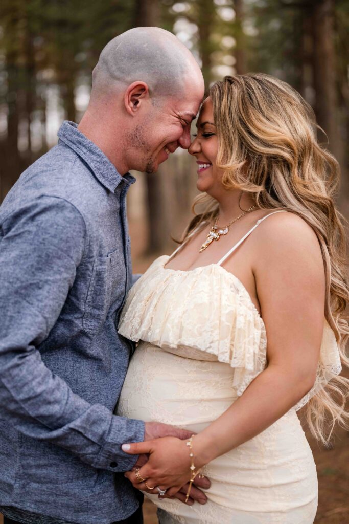 Joyful maternity couple photoshoot at Busch Conservation Area — expecting parents share an intimate moment in the forest, highlighting love, connection, and outdoor pregnancy photography inspiration.