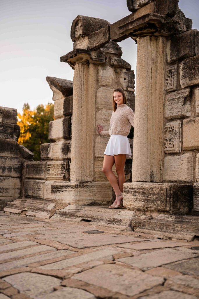 Teen girl standing in front of classic stone columns and steps at Tower Grove Park’s historic ruins.